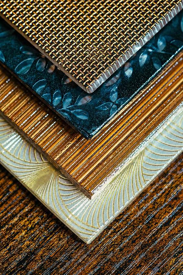 Stacked Veedrio glass texture samples in bronze and gold